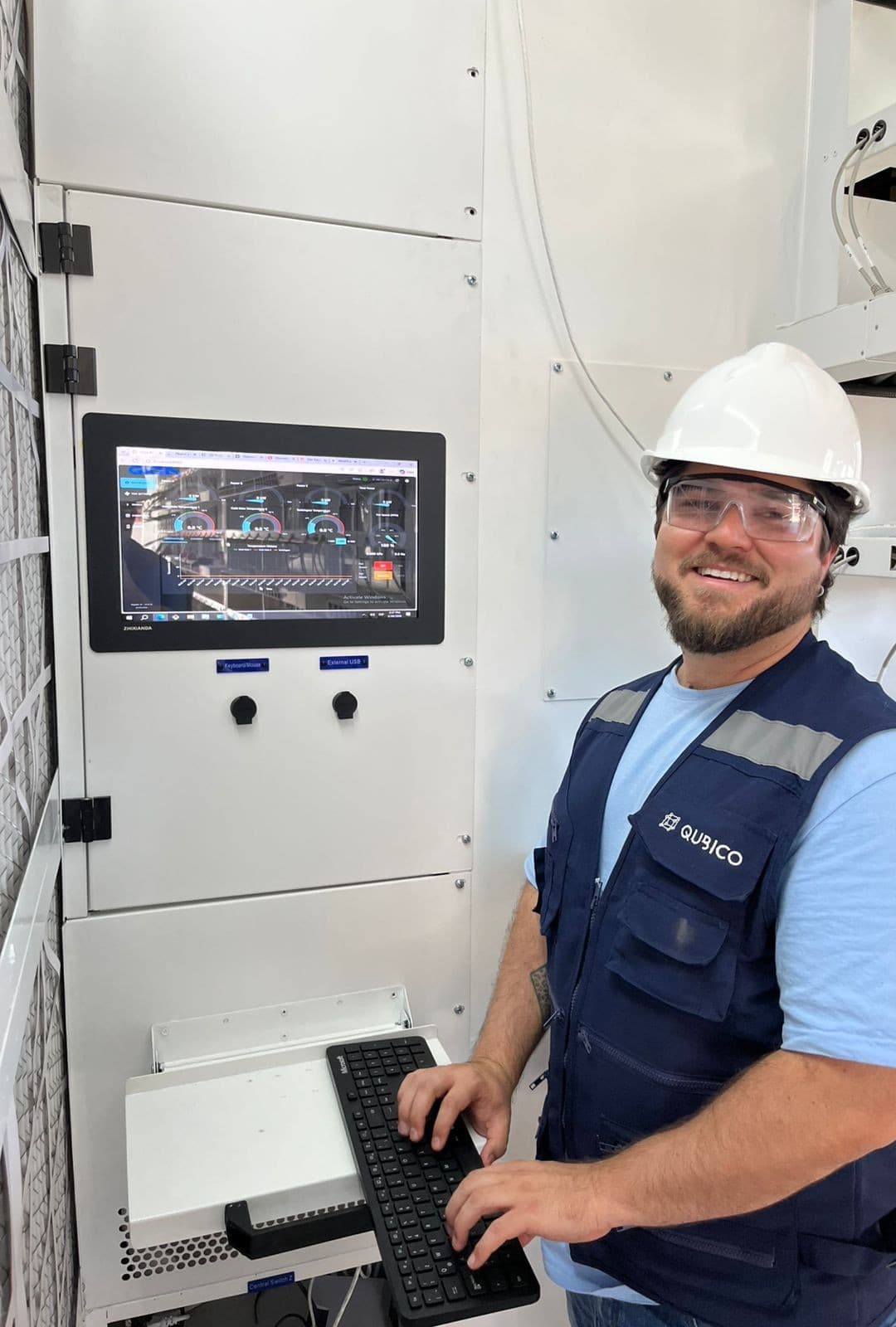 Qubico technician operating compute hardware in containerized infrastructure